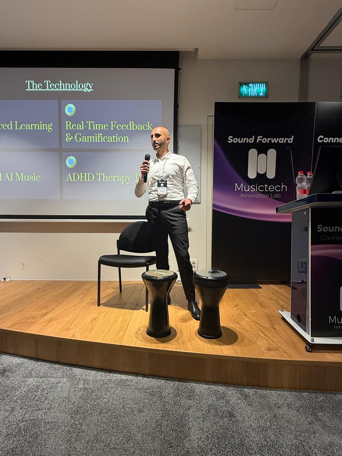 On stage at demo day — presenting the iDarbuka technology to investors and music-industry leaders.